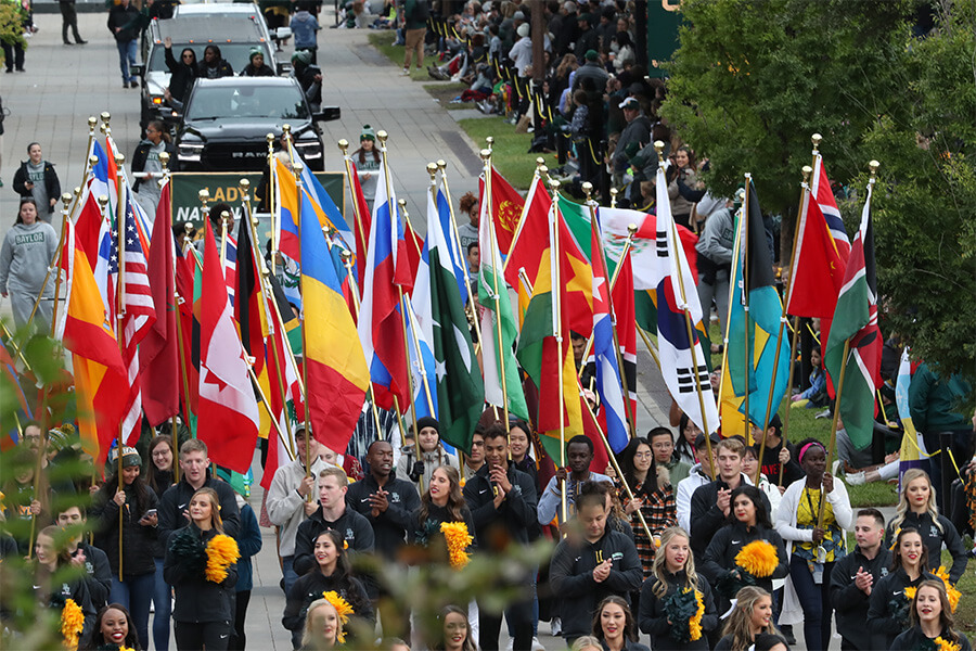 Photo of students holding flags on campus during parade