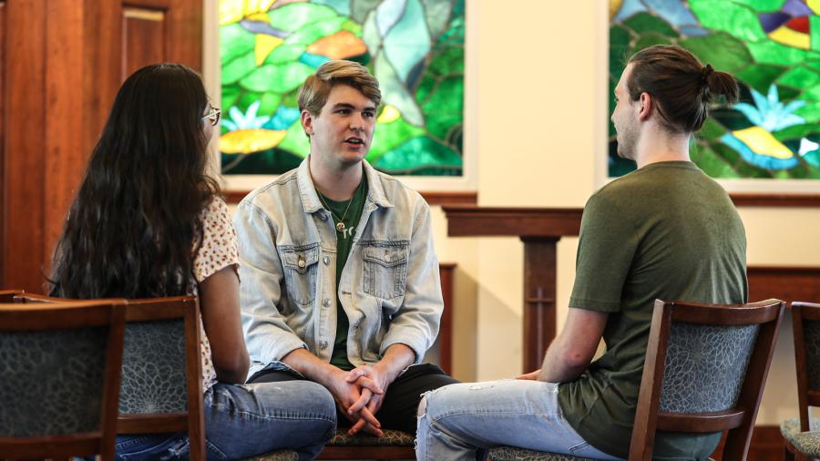 Students sitting talking on campus