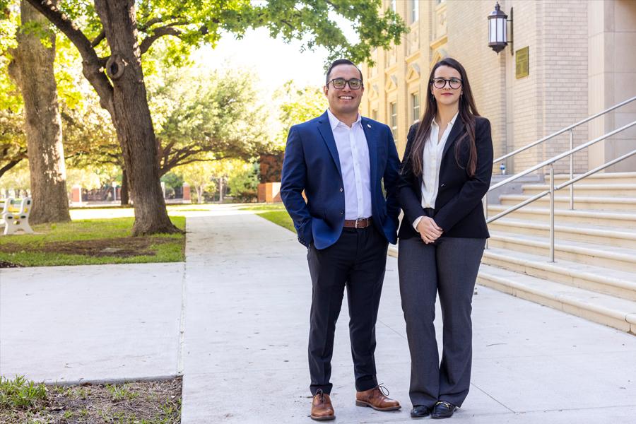 Dr. Marilia Corea and Dr. Ricardo Alvarez-Pimentel stand before Waco Hall on Baylor campus.