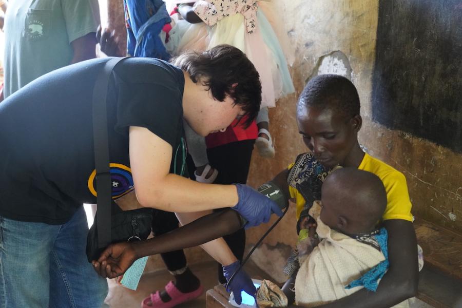 Baylor student provides medical assistance to mother and child on mission trip.