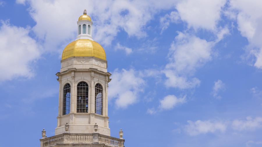 Pat Neff hall gold dome with blue sky behind